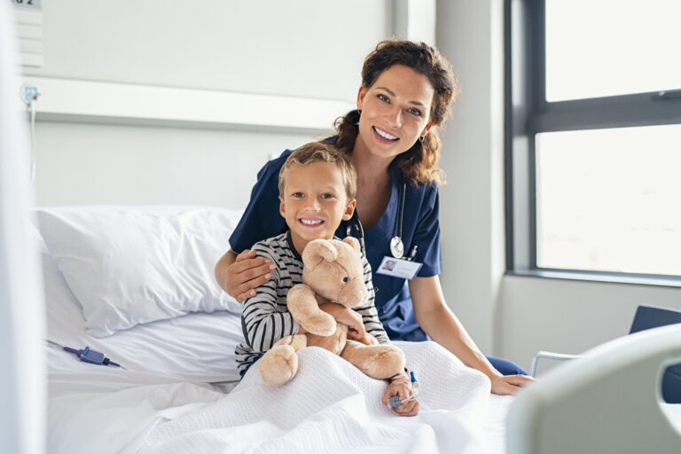 Happy Nurse With Smiling Kid At Hospital