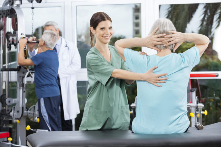 Female,Nurse,Assisting,Senior,Woman,In,Back,Exercise