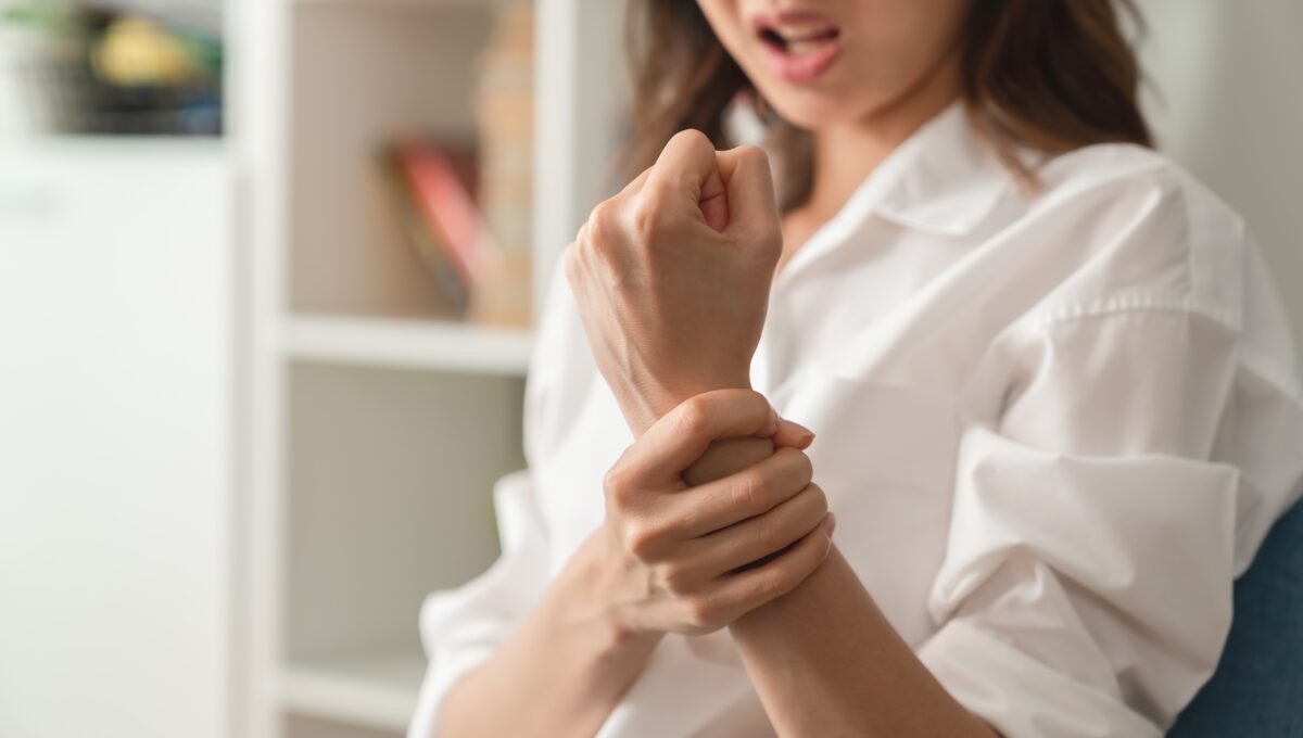 Close,Up,Of,Unhappy,Young,Woman,Having,Wrist,Pain,In