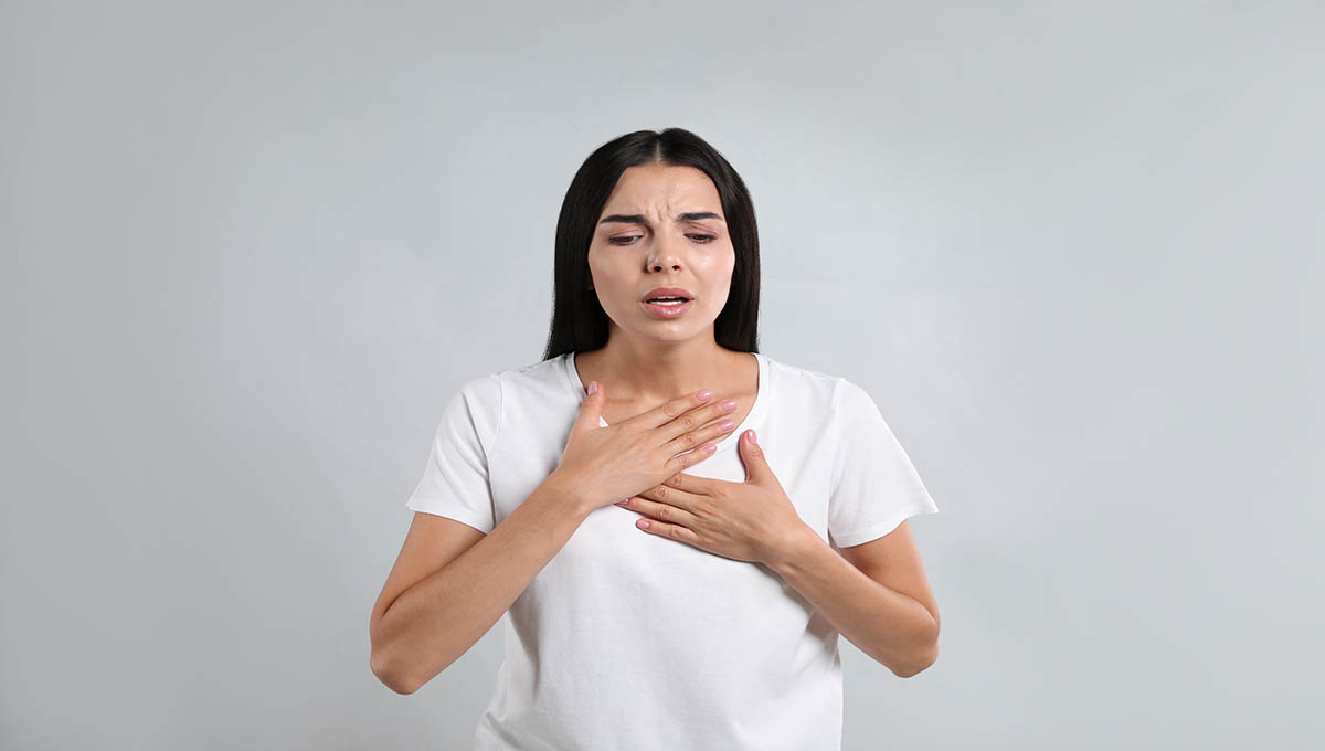 Young,Woman,Suffering,From,Breathing,Problem,On,Light,Background