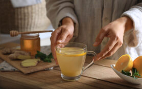 Woman,Making,Aromatic,Ginger,Tea,At,Wooden,Table,Indoors,,Closeup